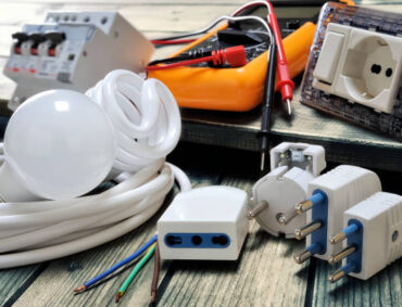 electrical image Close up of plugs and sockets and other components for residential electrical installation on rustic wooden table